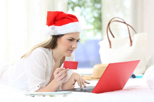 woman with santa hat on laptop
