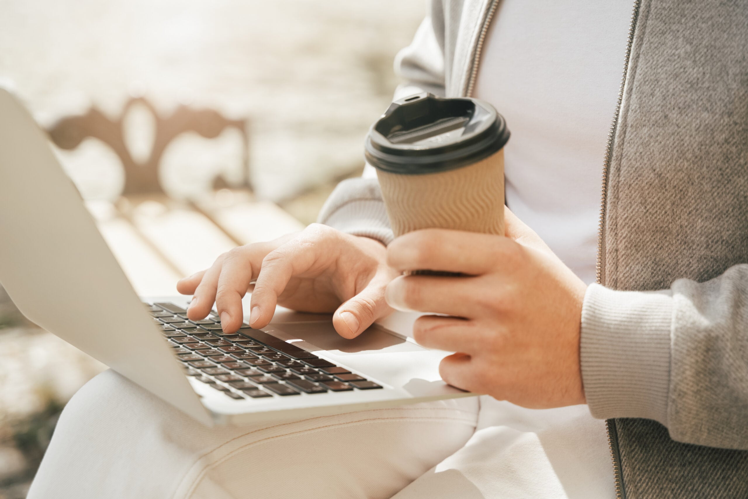 Person using a laptop, illustrating payoff wire fraud prevention and secure payoff verification for title companies